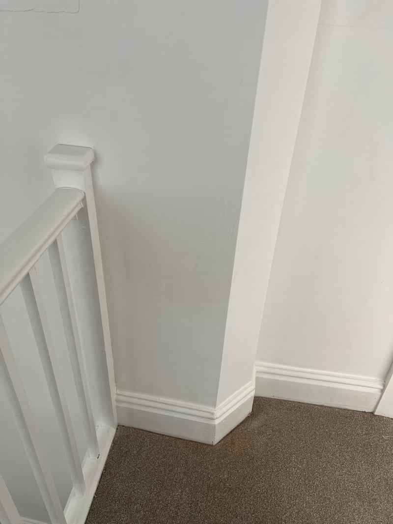 Same wall repaired, decorated and finished with clean skirting